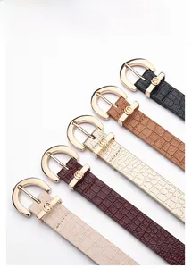 Detail of five PU leather belts in different colors with gold round zinc alloy buckles
