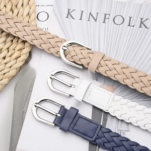 Women's woven faux leather belts in beige, white, and navy with silver metal buckles