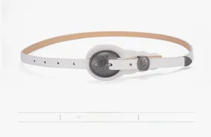 Detail of white slim belt with vintage floral embossed buckle and braided texture