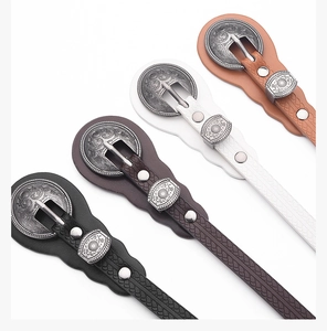 Detail of vintage women's slim belts with carved metal buckles in four classic colors