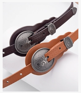 Detailed view of bohemian faux leather belts with vintage floral silver buckle and scales texture