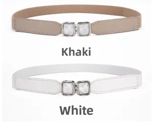 Detail of khaki and white elastic belts featuring metallic double buckles and sequins