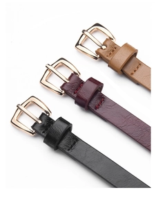 Close-up of slim PU leather belts in black, burgundy, and brown with gold pin buckles