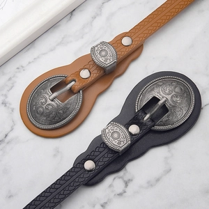 Vintage western-style thin waist belts with ornate carved metal buckles in black and brown