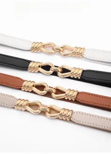 Detail of four versatile elastic waist belts with golden interlocking metal buckles