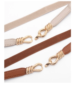 Detailed close-up of adjustable elastic waist belt with gold interlocking metal buckles