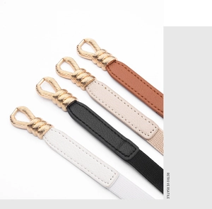 Detail of multi-color slim belts with vintage gold twisted metal buckles and leather texture