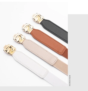 Detail of elastic waist belts in four colors with gold wavy metal buckles and leather texture