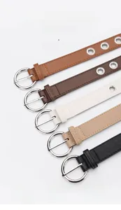 Close-up of five colorful leather belts with metal eyelets and silver alloy buckles