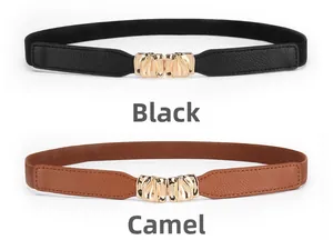 Detail of slim elastic belts in black and camel with gold wavy metal buckles