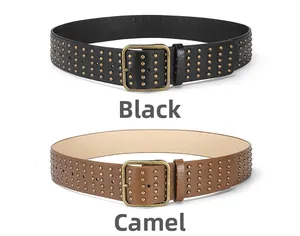 Detail view of black and camel punk wide belts with rows of gold rivets and square buckles