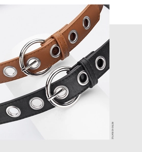 Detail of retro punk belts with double ring buckles and silver metal eyelets