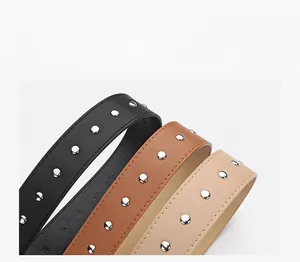 Detail of PU leather belts with decorative silver studs and fine stitching in three colors
