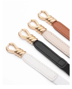 Detail of four thin leather belts with elegant interlocking golden buckles in various colors