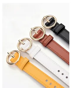 Close-up of golden alloy round pin buckles and premium leather belts in multiple colors