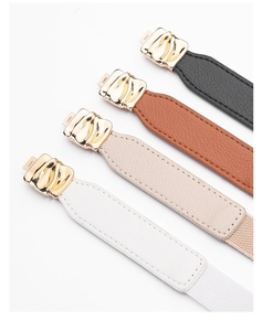 Detailed view of four thin elastic waist belts with gold wave buckles in black and brown