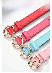 Detail of colorful children's belts featuring gold round buckles and star eyelet patterns