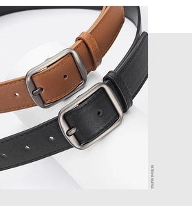 Detail view of brown and black leather belts with matte silver metal pin buckles