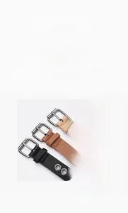 Close-up of minimalist leather belts with large metal eyelets and matte square buckles