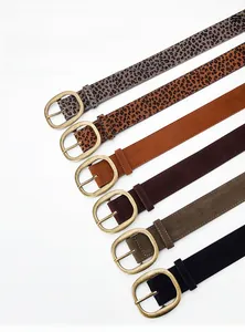 Detail of six faux suede belts with vintage gold buckles in leopard and solid colors