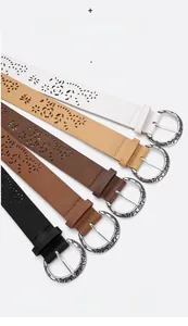 Detailed view of alloy buckles and floral hollow patterns on five leather belts