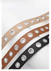 Detail view of khaki, brown, and black punk PU leather belts with metal eyelets
