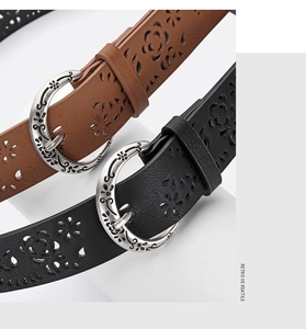 Detail of vintage carved floral hollow belts in brown and black with rustic silver buckles