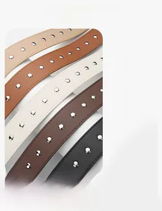 Detail of PU leather belts with metal rivets in black, brown, beige, and white colors