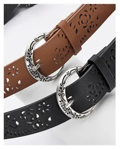 Detail of vintage laser-cut floral belts with engraved alloy buckles in black and brown