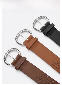 Detailed view of vintage hollowed-out leather belts with engraved zinc alloy buckles