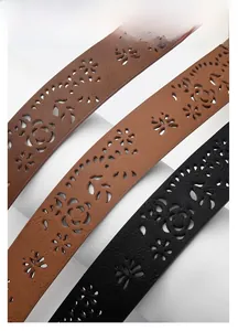 Close-up of vintage hollowed-out pattern on PU leather belts in black and brown