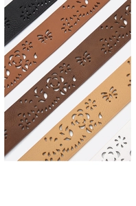 Close-up of vintage hollow floral leather belts in multiple colors with rose patterns