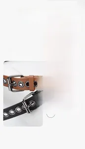 Detail of slim leather belts with metal eyelets in black, brown and khaki colors