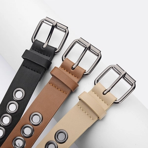 Three minimalist eyelet belts in black, brown, and beige with gunmetal pin buckles
