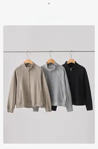Detailed view of casual men's zip-up jackets in black, light grey, and cream white colors