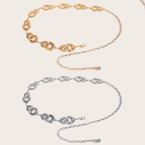 Detailed view of adjustable gold and silver metal chain belts with double-ring buckle
