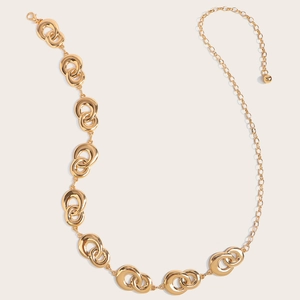 Detail view of gold layered interlocking oval links with lobster clasp and bead charm