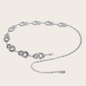 Detail view of a polished silver metal chain belt with interlocking oval links and lobster clasp