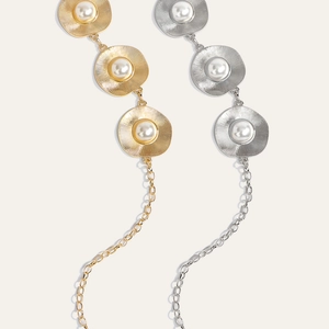 Detailed view of metal discs with pearls in gold and silver for belts and dresses
