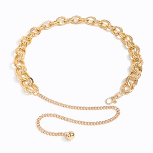 Detail view of golden metal waist chain with textured rings and round ball pendant charm