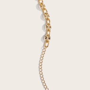 Detailed view of hollow gold metal waist chain belt with engraved oval links and adjuster