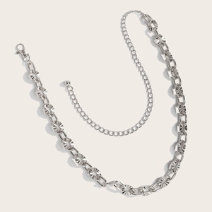 Macro detail of a silver hollow metal waist chain with sunburst etched texture rings
