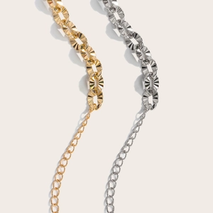 Detailed view of dual-tone metal hollow waist chains with oval textured links