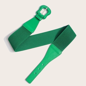 Macro shot of stylish bright green elastic belt with woven texture and leather details