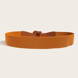 Detail view of orange elastic wide belt with brown faux leather front clasp design