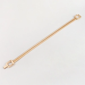Detail of elegant gold elastic waist chain with brushed texture and geometric buckle