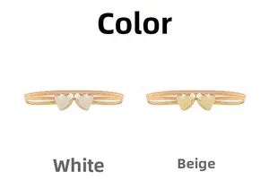 Detail of double heart buckle metal belts in white and beige enamel for dresses