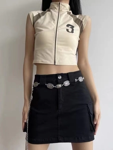 Detail of silver metal waist chain with vintage textured oval links on black cargo skirt