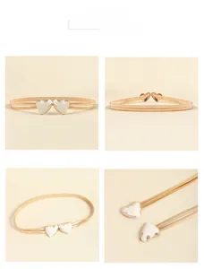 Detail view of the golden spring waist chain with white double heart buckle for dresses