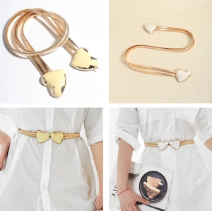 Detailed close-up of a gold spring waist chain featuring a polished heart-shaped buckle